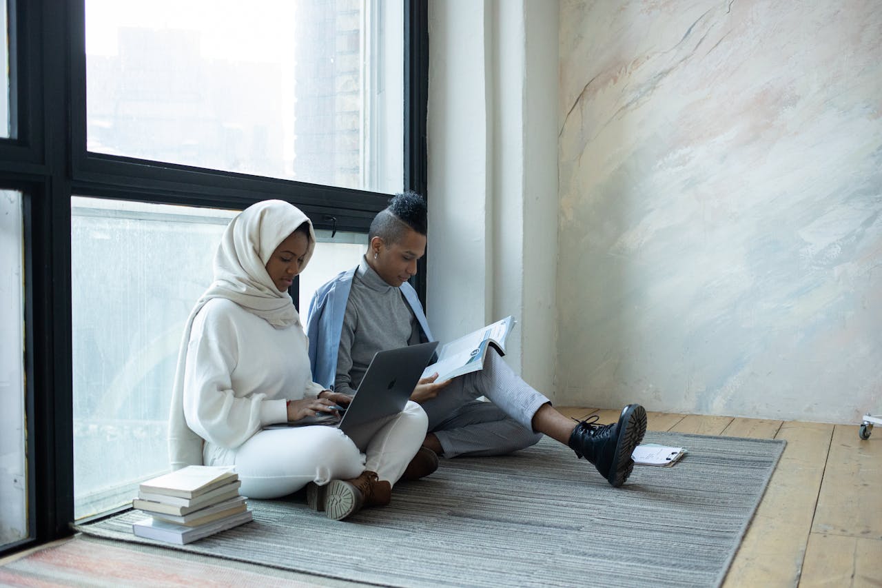 Serious black students doing assignment together